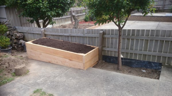 Raised veggie bed on sloping site by Yummy Gardens Melbourne